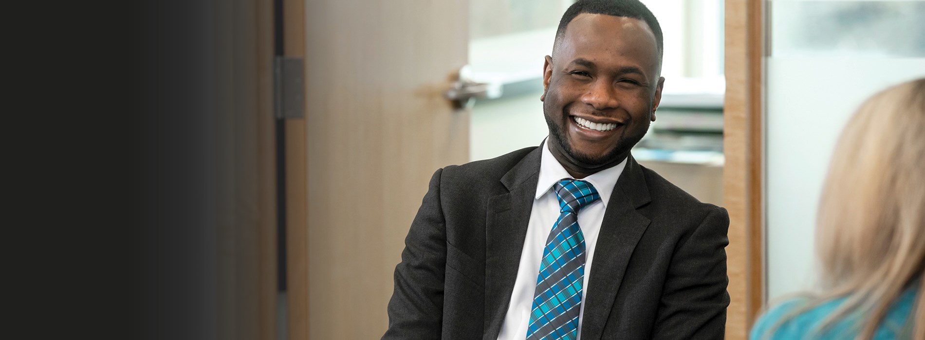 Man in a suit smiling